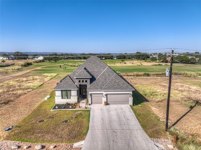 505 John Price St, Blanco, TX 78606 - view of front facade featuring an attached garage, concrete driveway, and a front lawn