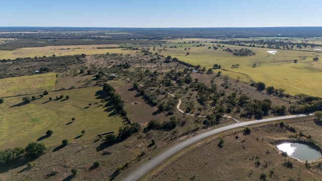 drone / aerial view with a water view and a rural view