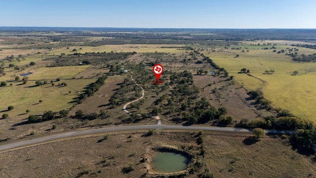 birds eye view of property with a rural view