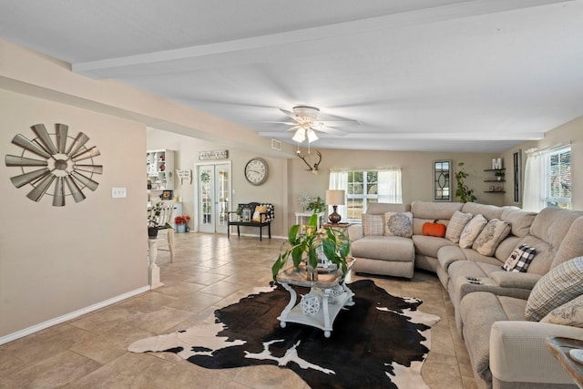 living room with beamed ceiling, ceiling fan, and french doors