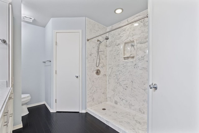 6803 Fence Line Dr, Austin, TX 78749 - full bathroom featuring vanity, a marble finish shower, wood finished floors, and recessed lighting