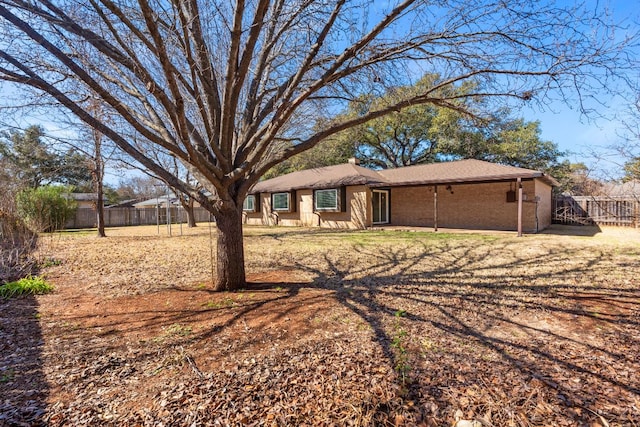 single story home featuring fence