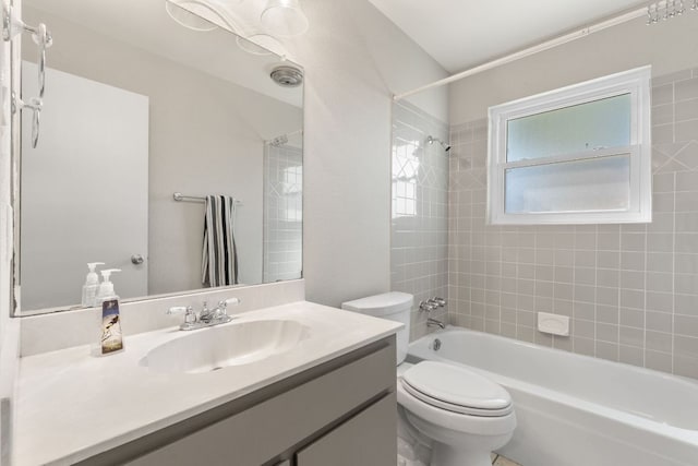 bathroom featuring bathtub / shower combination, vanity, and toilet