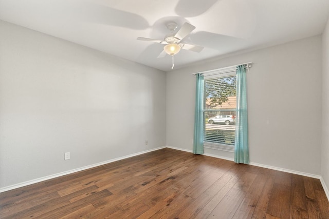 spare room featuring baseboards, ceiling fan, and hardwood / wood-style floors