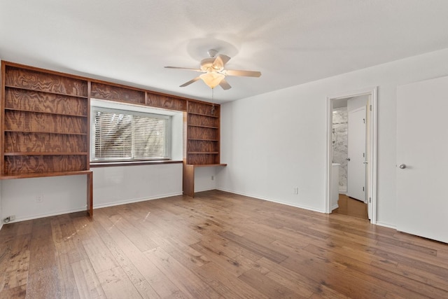 empty room featuring ceiling fan, hardwood / wood-style floors, and baseboards