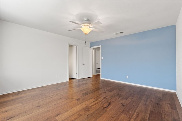 spare room with a ceiling fan, baseboards, visible vents, and hardwood / wood-style floors