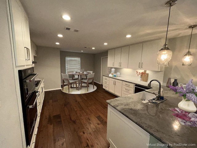 6803 Fence Line Dr, Austin, TX 78749 - kitchen with white cabinetry, a sink, dark wood-style flooring, recessed lighting, and baseboards