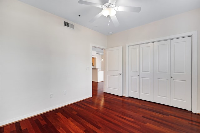 unfurnished bedroom with dark wood-type flooring and ceiling fan