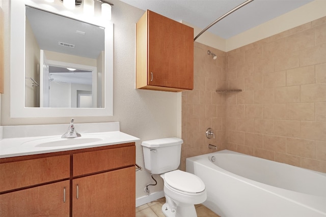 full bathroom with vanity, toilet, tiled shower / bath combo, and tile patterned flooring