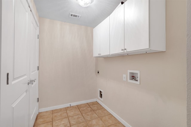 laundry area with cabinets, hookup for an electric dryer, washer hookup, and light tile patterned floors