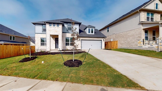 view of front facade with a garage and a front yard