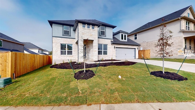 view of front of home featuring a garage and a front lawn