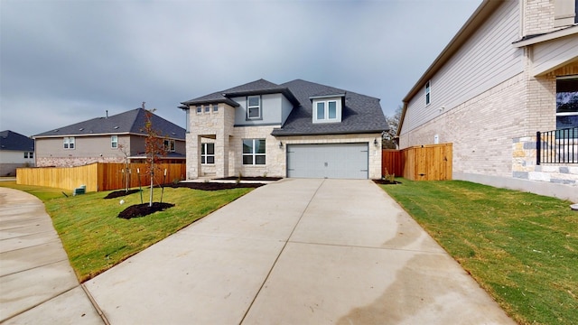 view of front of home featuring a front yard and a garage