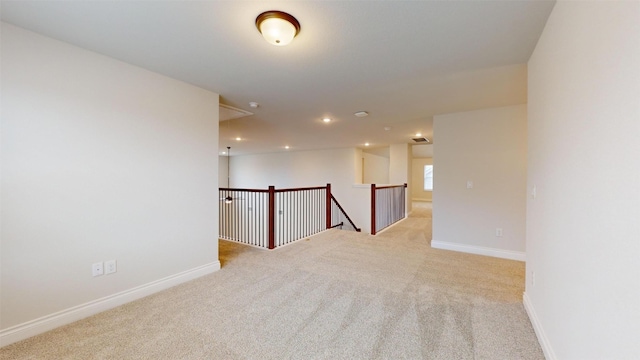 empty room featuring light carpet