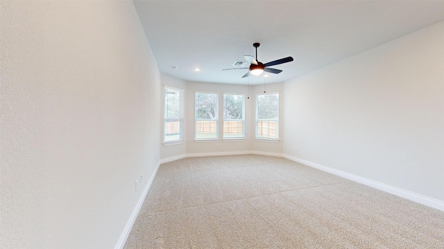 spare room featuring carpet flooring and ceiling fan