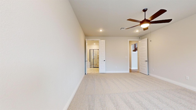 carpeted spare room featuring ceiling fan