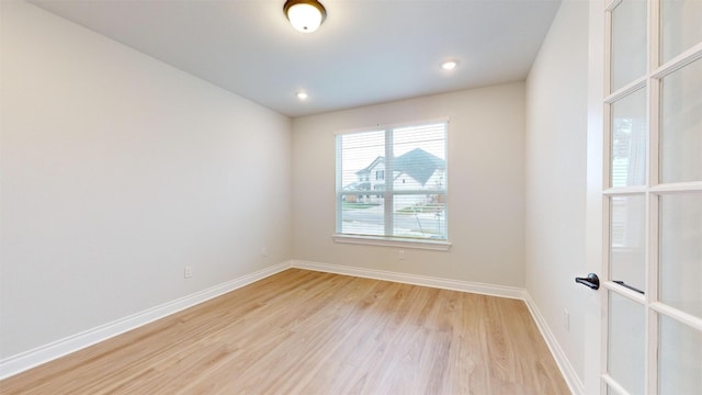 unfurnished room with light hardwood / wood-style flooring