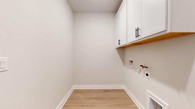 clothes washing area with cabinets, hookup for a washing machine, gas dryer hookup, electric dryer hookup, and light hardwood / wood-style flooring