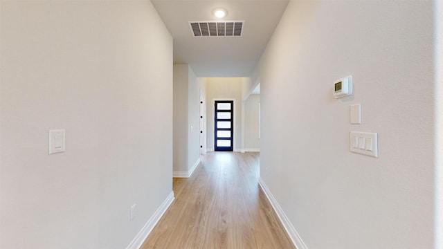 hall with light wood-type flooring