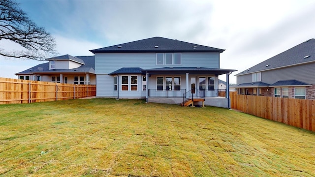 back of property with covered porch and a yard