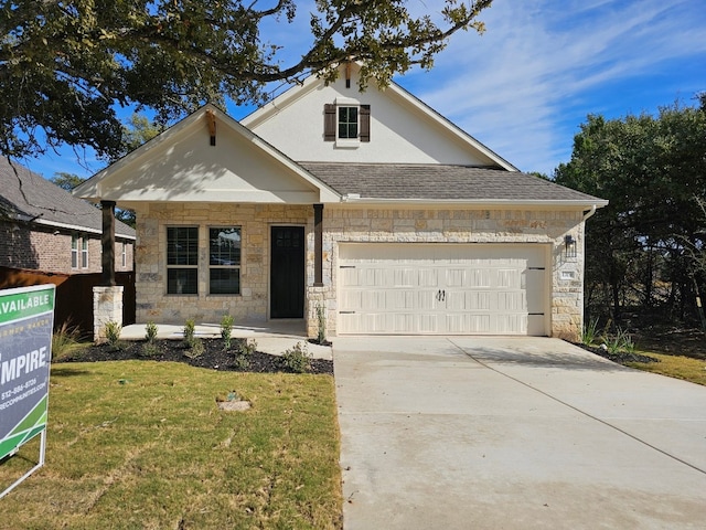 view of front of home with a front yard and a garage