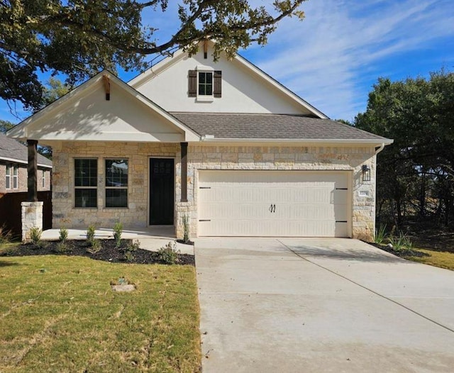 1709 Garret Oaks Ln, Georgetown, TX 78633 - view of front facade featuring stone siding, a garage, concrete driveway, a front lawn, and stucco siding