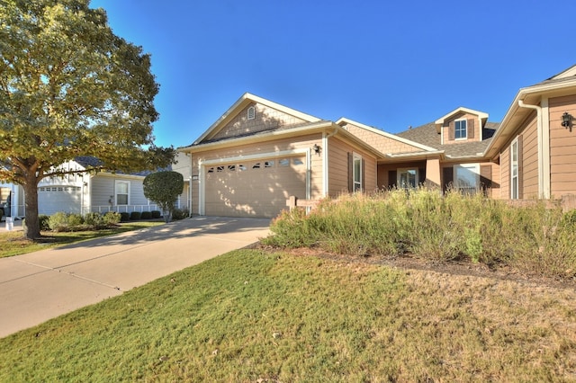 view of front of home with a front lawn and a garage