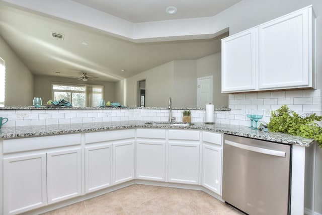 kitchen featuring white cabinets, tasteful backsplash, stainless steel dishwasher, and sink