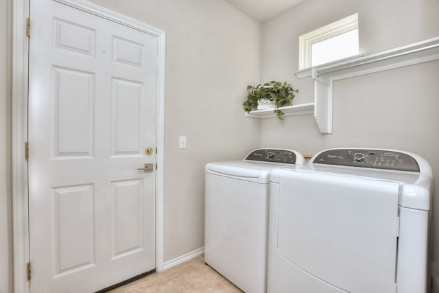 washroom with independent washer and dryer and light tile patterned flooring