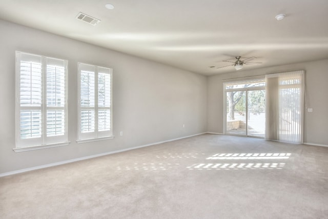 spare room with light carpet and ceiling fan