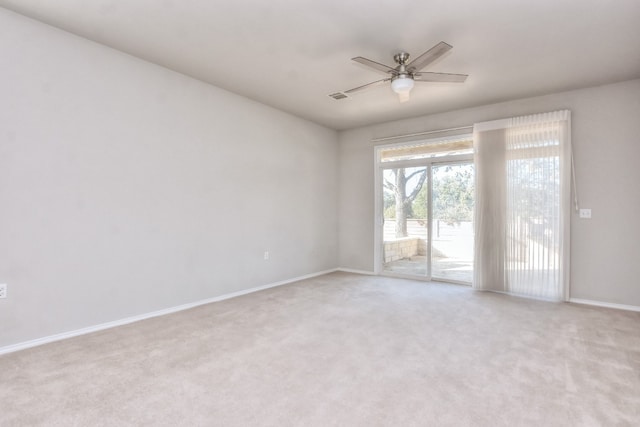 empty room with ceiling fan and light colored carpet