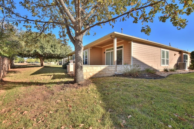 exterior space featuring a yard and central AC unit