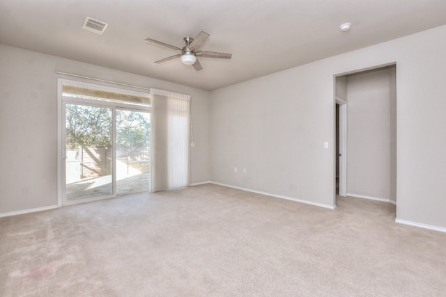 carpeted spare room with ceiling fan