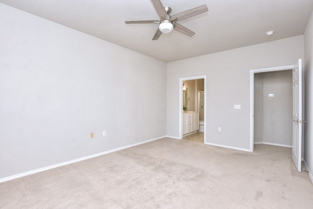 unfurnished bedroom with light carpet, ensuite bathroom, and ceiling fan