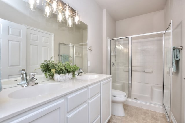 bathroom with vanity, toilet, and a shower with door