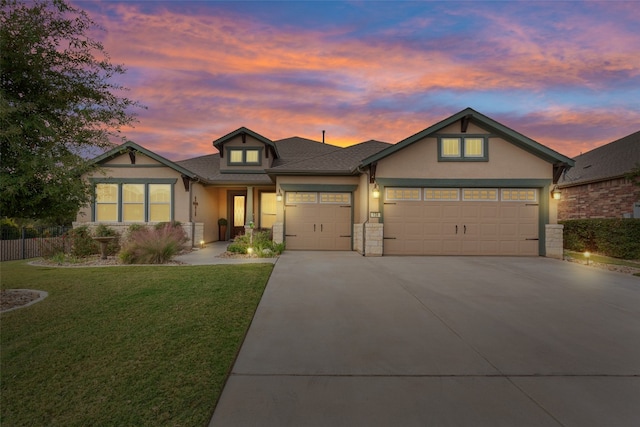 view of front of house with a garage and a lawn