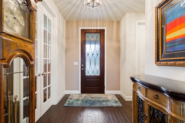 entryway with a chandelier and dark wood-type flooring