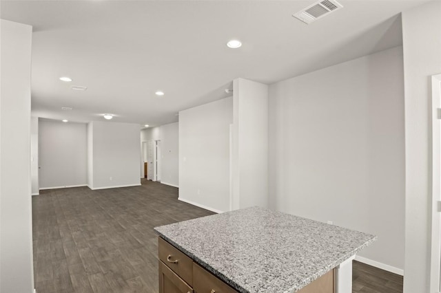 196 Lavender Ln, Elgin, TX 78621 - kitchen featuring a kitchen island, light stone countertops, dark wood-style floors, visible vents, and recessed lighting