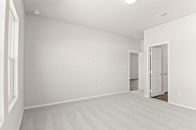 196 Lavender Ln, Elgin, TX 78621 - unfurnished bedroom with carpet flooring and connected bathroom