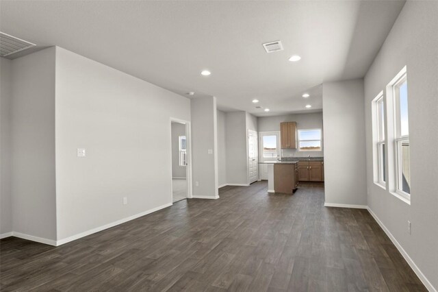 196 Lavender Ln, Elgin, TX 78621 - unfurnished living room with dark wood-type flooring and recessed lighting