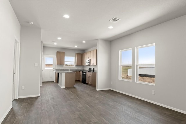196 Lavender Ln, Elgin, TX 78621 - kitchen with a center island, dark wood-type flooring, baseboards, visible vents, and black range with gas stovetop