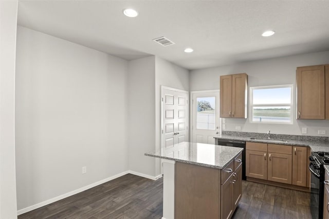 196 Lavender Ln, Elgin, TX 78621 - kitchen with a sink, light stone countertops, dishwasher, black gas stove, and dark wood-type flooring