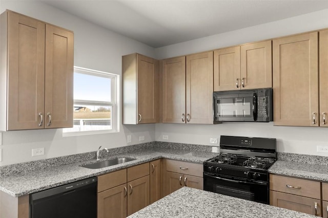 196 Lavender Ln, Elgin, TX 78621 - kitchen with a sink, light stone countertops, black appliances, and light brown cabinetry