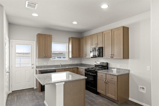 196 Lavender Ln, Elgin, TX 78621 - kitchen with a center island, dark wood-style floors, black appliances, and visible vents