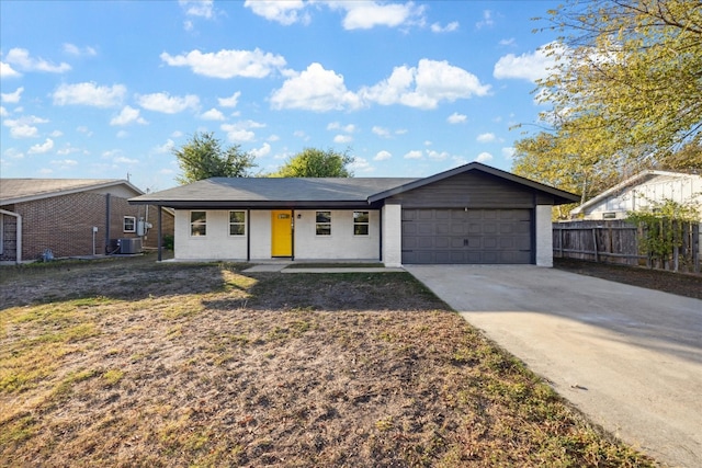 single story home featuring central AC and a garage