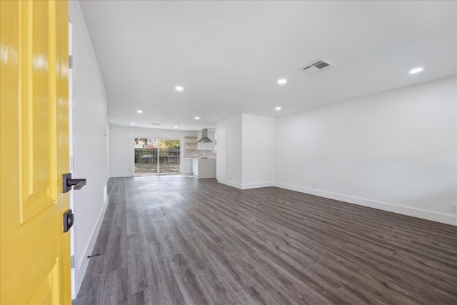 unfurnished living room featuring dark hardwood / wood-style flooring