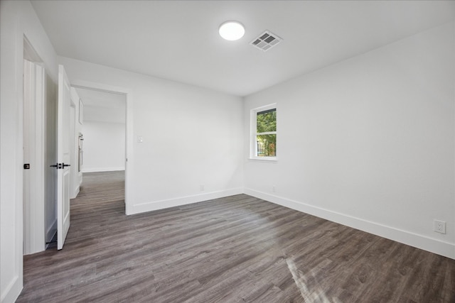 spare room featuring dark wood-type flooring