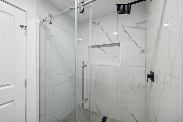 bathroom featuring a shower with door