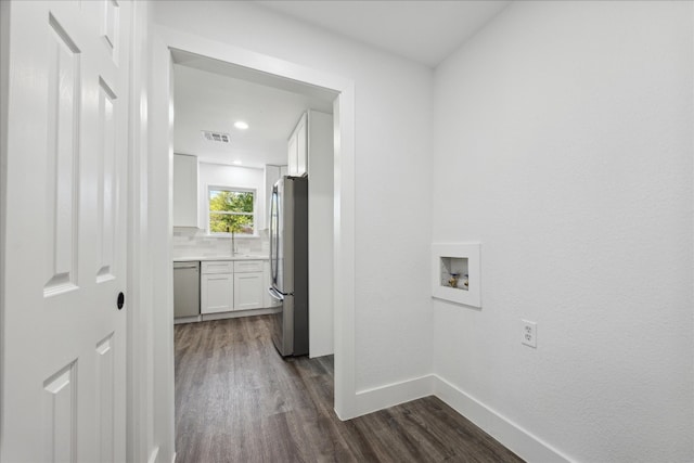 washroom featuring sink, hookup for a washing machine, and dark hardwood / wood-style flooring