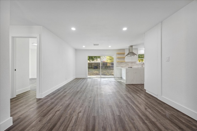 unfurnished living room featuring dark hardwood / wood-style flooring